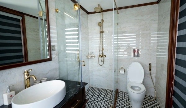 Modern luxury bathroom featuring glass shower enclosure, vessel sink, and custom plumbing fixtures installation in LA County.